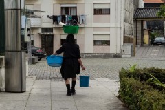 Lady balances washing on her head